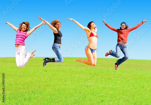 Girls jump on a meadow