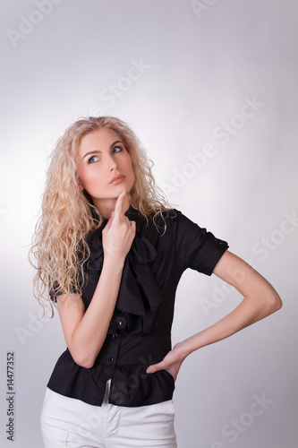 Photo of a businesswoman looking up and thinking