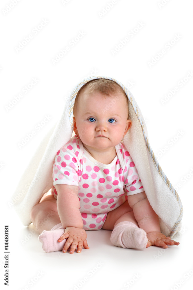 Cute baby sitting with towel on head isolated over white Cute baby sitting with towel on head isolated over white