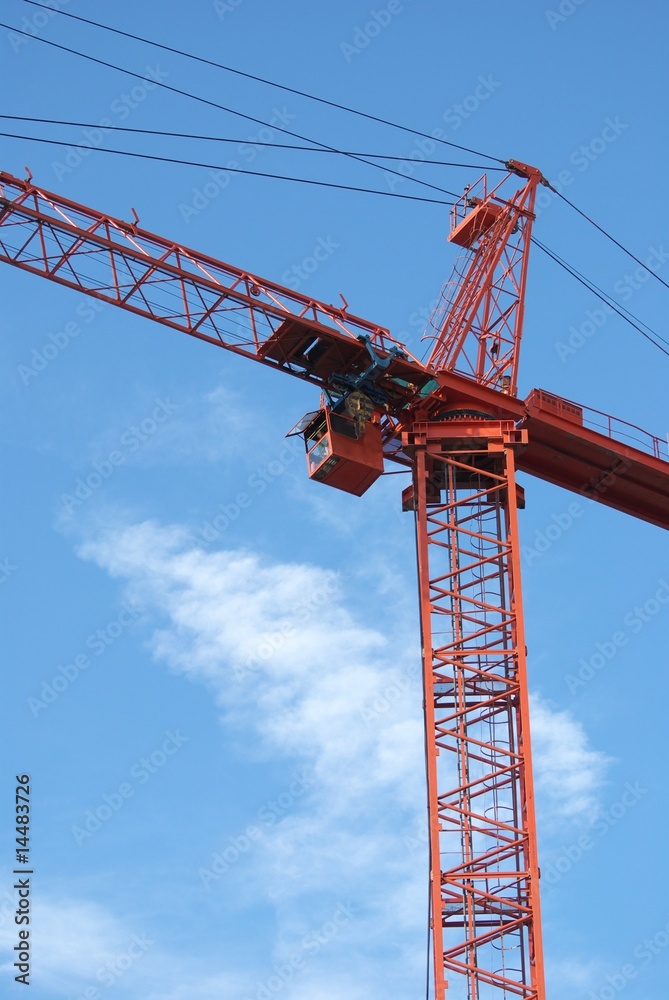 A red crane at blue sky background A red crane at blue sky background
