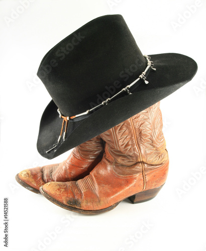 Old black cowboy hat and boots