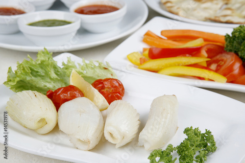 Calamary Squid to prepare a tomato pepper decoration greener photo