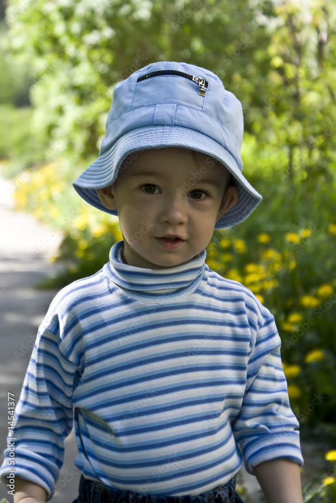 Half-length portrait of the little boy on a background of a summ Half-length portrait of the little boy on a background of a summ