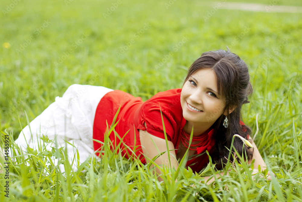 Beautiful girl lying on the grass Beautiful girl lying on the grass
