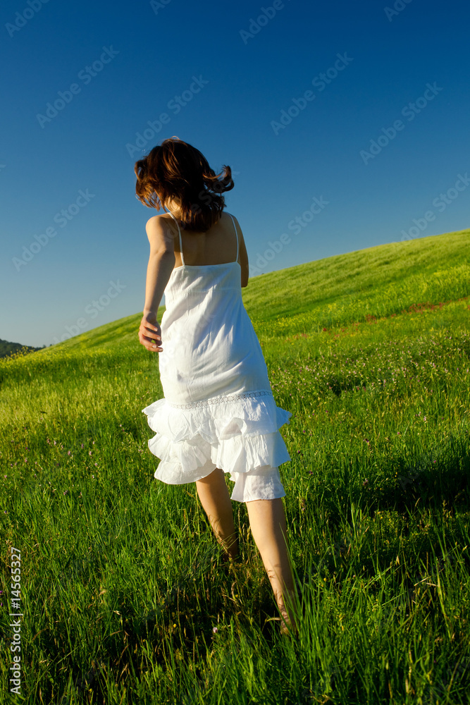 Young woman running on a beautiful springfield Young woman running on a beautiful springfield