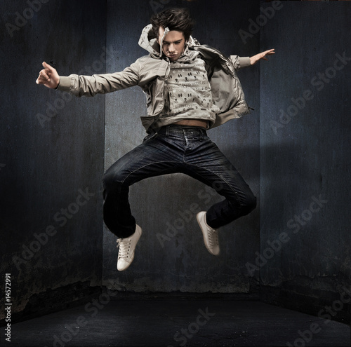 Fototapeta Naklejka Na Ścianę i Meble -  Young hip-hop dancer over a grunge wall