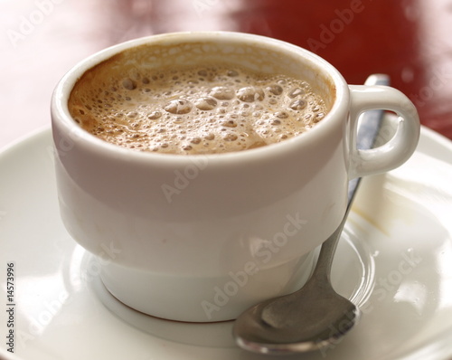 Coffe with milk in white cup - Spanish cortado.