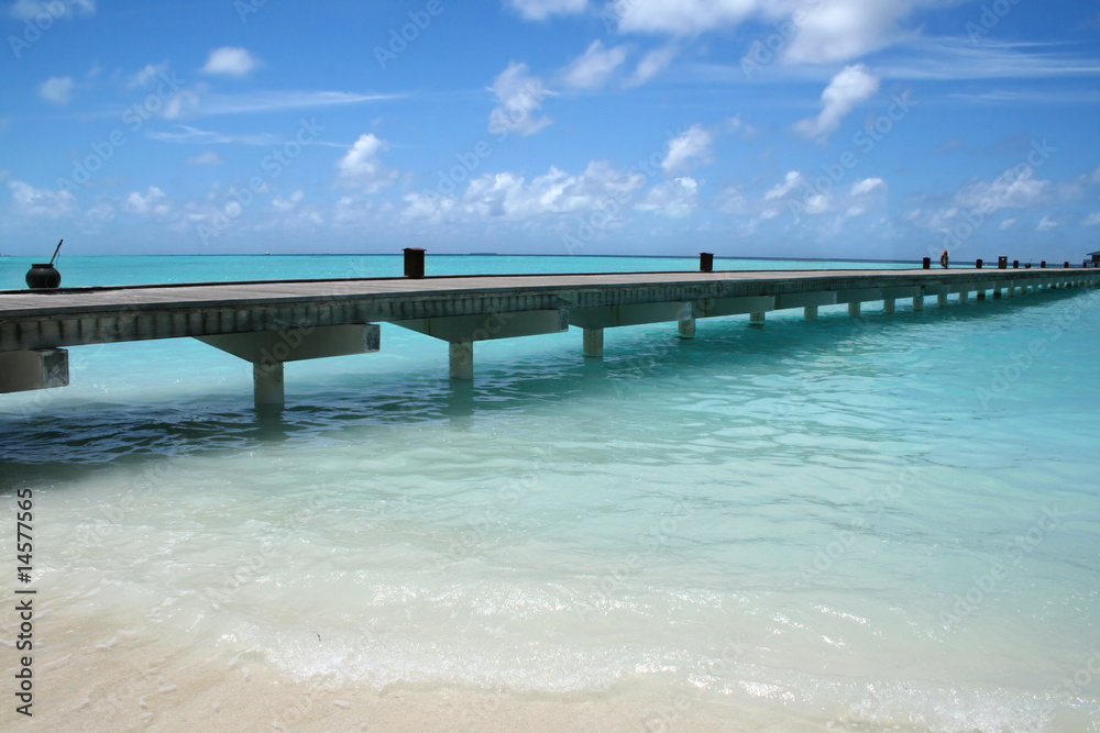 Wooden jetty on over the beautiful Maldivian beach