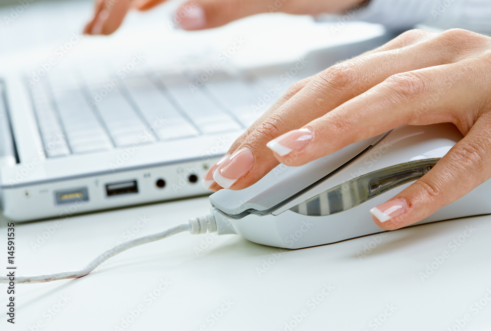Female hand using computer mouse Female hand using computer mouse
