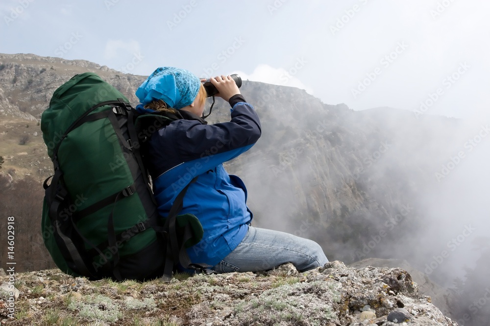 Girl in mountains using her binocular. Girl in mountains using her binocular.