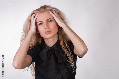 Canvas Print Blond young woman with a pounding headache