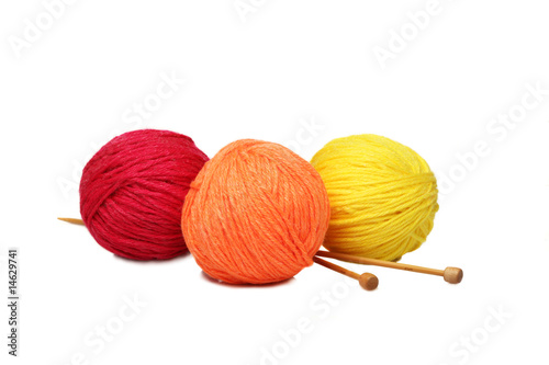 Colorful yarn balls and knitting needles isolated on white background