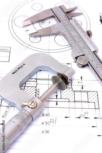 Caliper and Micrometer on blueprint vertical. Shallow dof