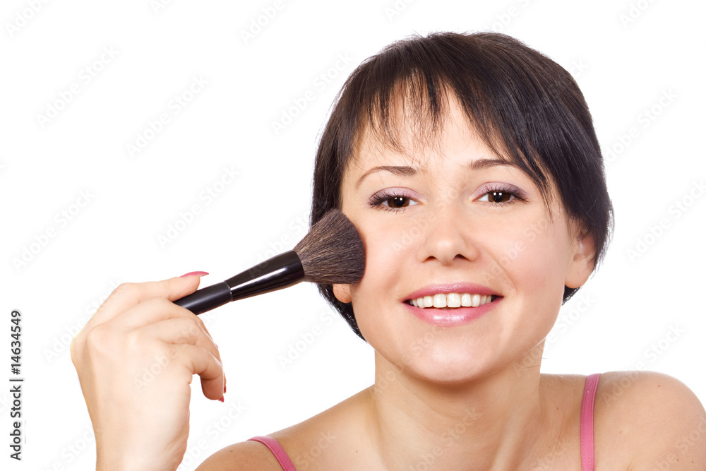 Young woman applying powder on her face Young woman applying powder on her face