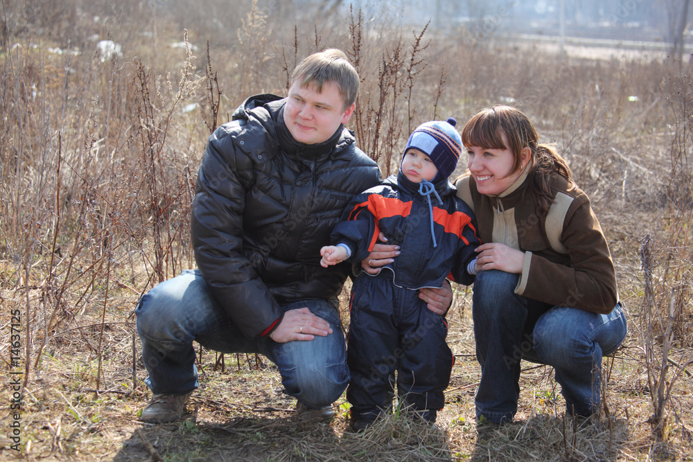 Parents with child outdoor in spring