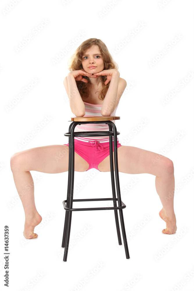 Girl in sportswear leans against  bar stool