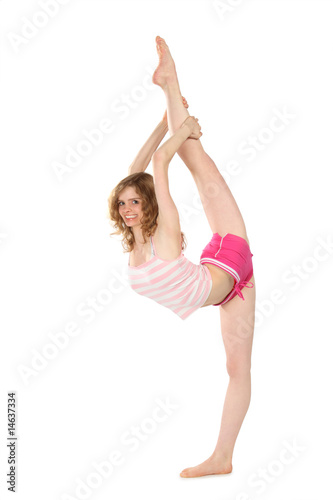 Smiling girl in sportswear does gymnastic exercise