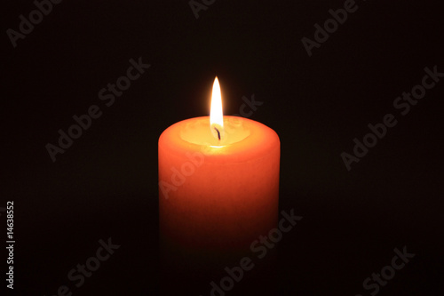 Candle glowing in the dark