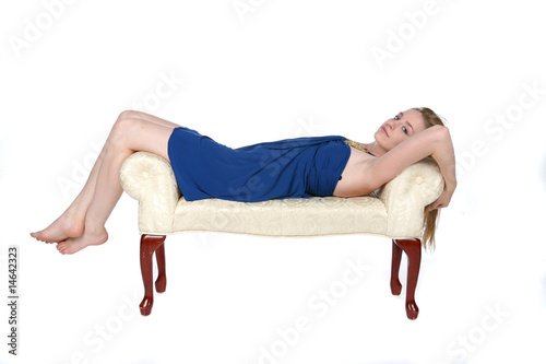 beautiful young woman reclinging on white bench photo
