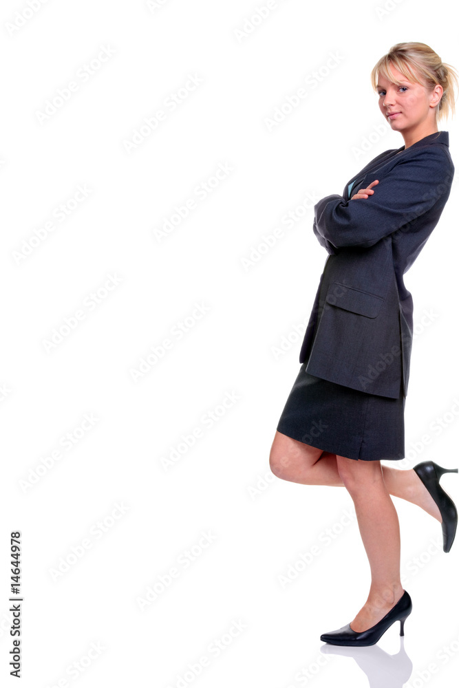 Blond businesswoman in suit leaning against blank wall Blond businesswoman in suit leaning against blank wall