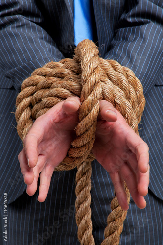 Businessman hands tied up with rope