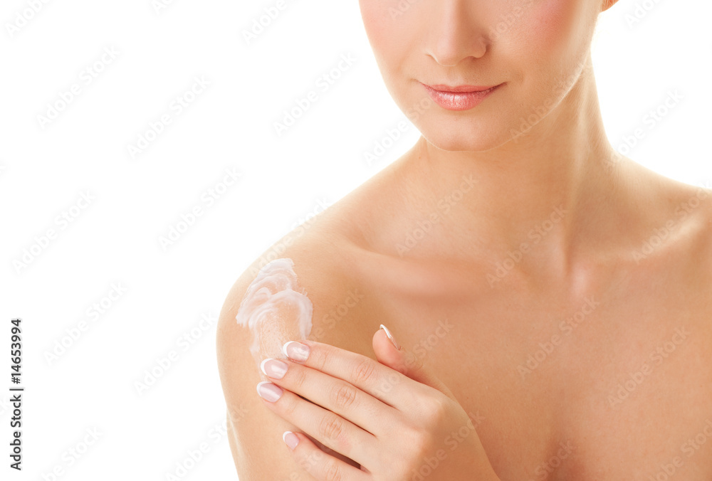Young beautiful woman applying moisturizer to her skin after sho Young beautiful woman applying moisturizer to her skin after sho