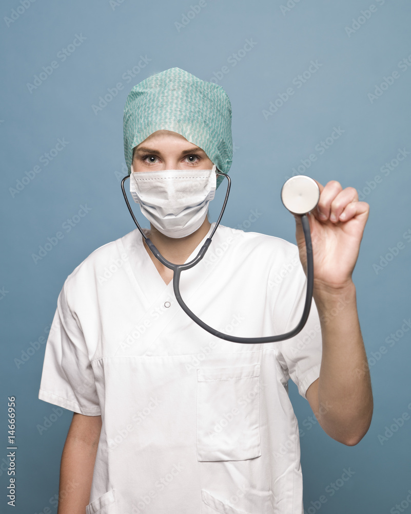 Female nurse with surgical mask and a stethoscope Female nurse with surgical mask and a stethoscope