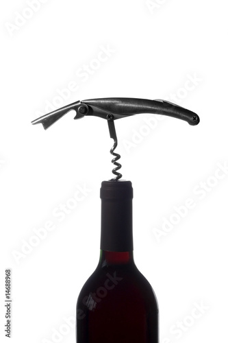 Silhuette of a bottle opener and a red wine bottle photo