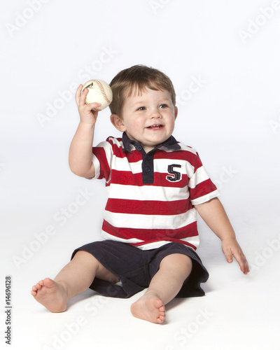 little boy on floor with baseball