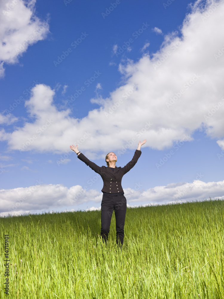 Young woman with her arms raised outdoor Young woman with her arms raised outdoor
