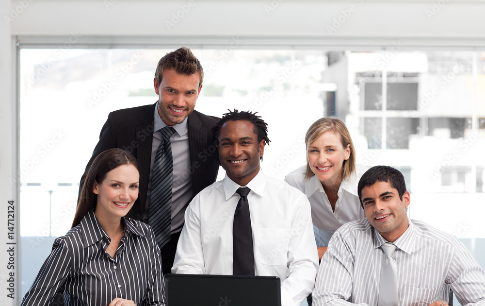 Business team working in an office looking at the camera Business team working in an office looking at the camera