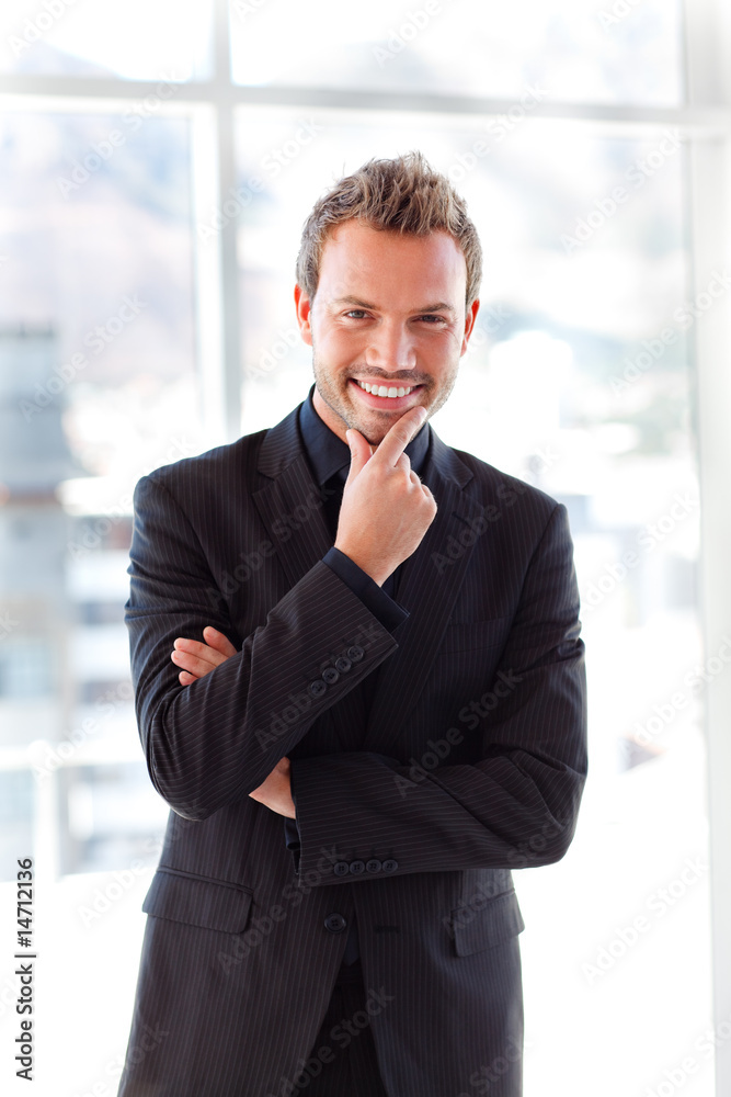 Attractive businessman smiling at the camera Attractive businessman smiling at the camera