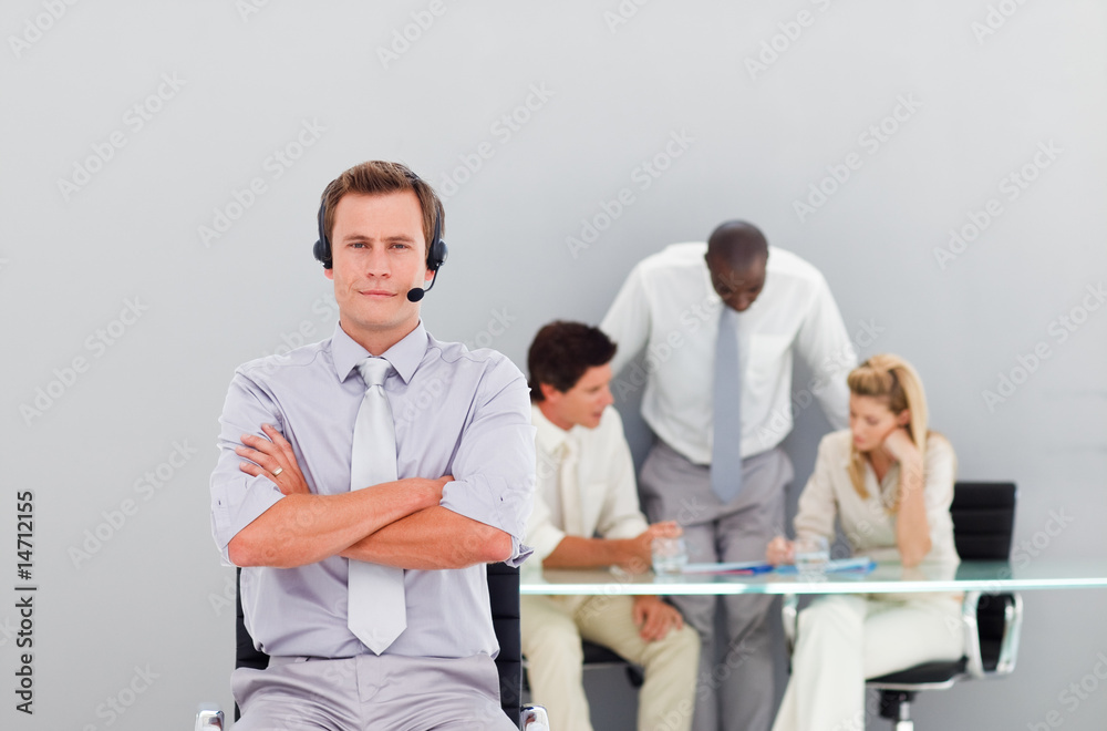 Businessman with a headset on with folded arms Businessman with a headset on with folded arms