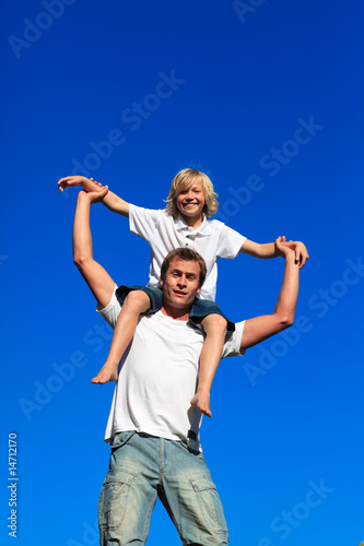 Father giving his son a piggyback ride