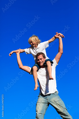 Father giving his son a piggyback ride