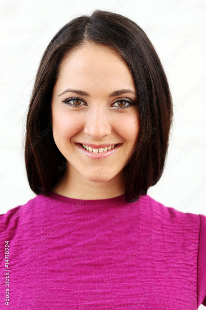 Beautiful woman standing against wall in background Beautiful woman standing against wall in background