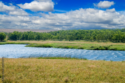 lagoon of small lake with cloud on the sky and strong waves