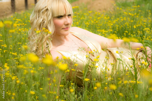 Beautiful girl in dold dress in yellow flowers