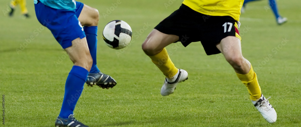 Soccer players running after the ball Soccer players running after the ball