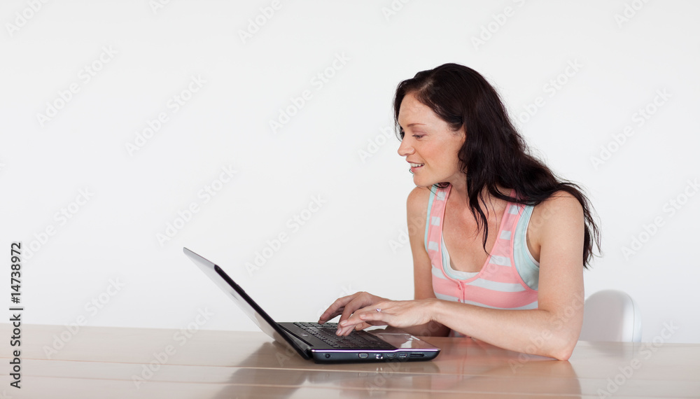 Smiling woman using her laptop with copy-space Smiling woman using her laptop with copy-space