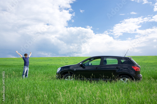 Happy young man and his first car