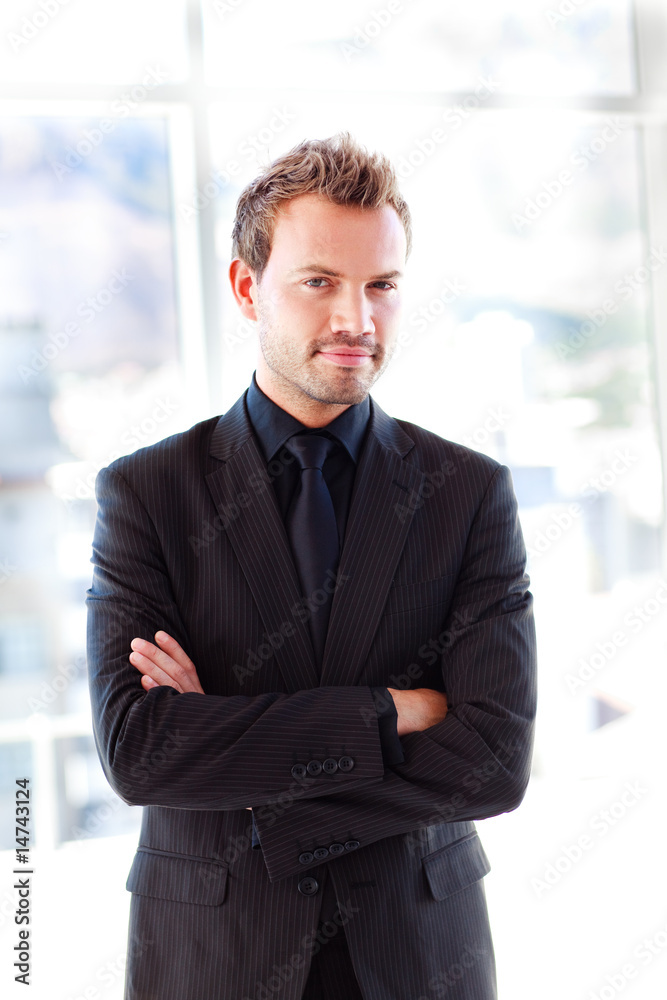 Attractive confident businessman with folded arms Attractive confident businessman with folded arms