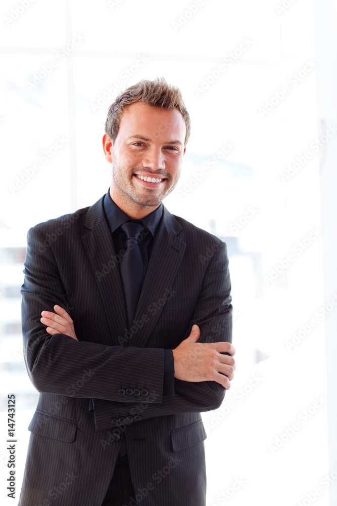 Handsome smiling businessman with folded arms Handsome smiling businessman with folded arms