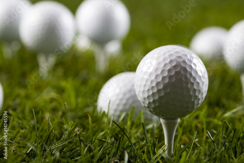 Golf ball on tee in grass