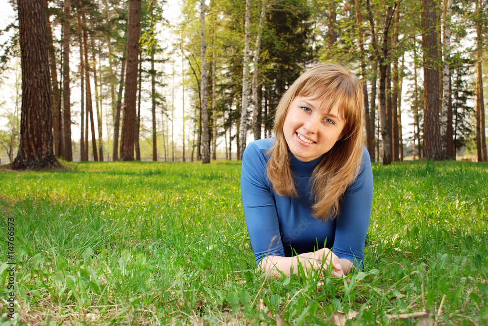 Fototapeta premium The young girl on a grass