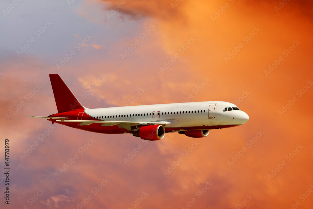 Fototapeta premium airplane in air on sunrise sky