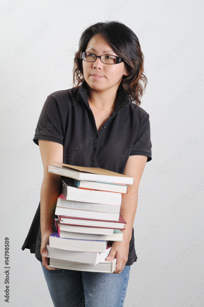 woman holding stack of books woman holding stack of books
