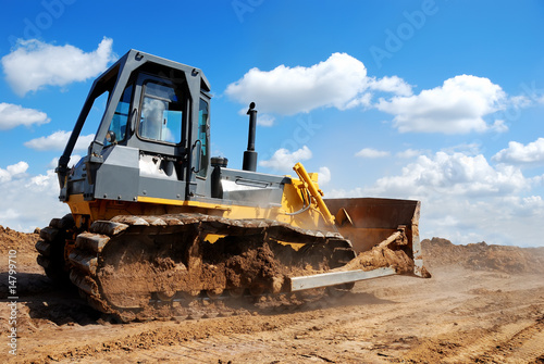 bulldozer with raised blade in action