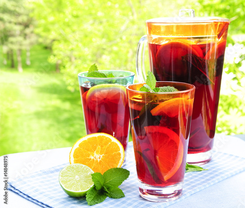 Fruit punch in pitcher and glasses photo