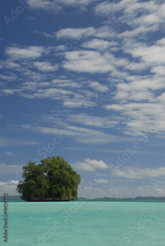 Single tropical island in blue lagoon